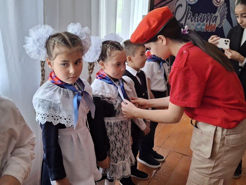 надевает значок